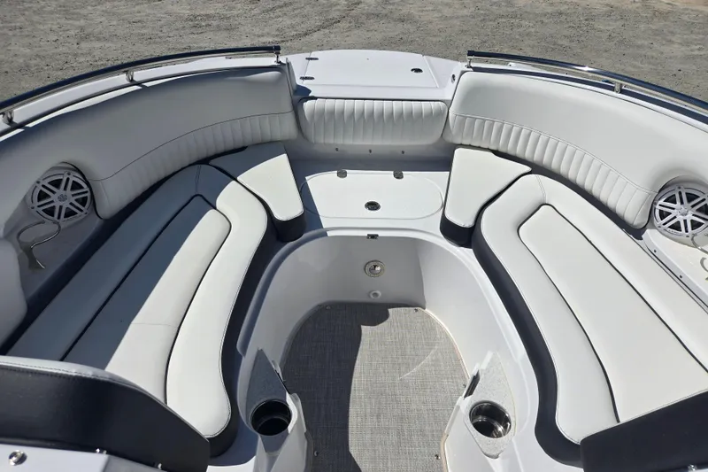 Slide: The Image of 2026 Stingray 231 DC boat interior with white cushioned seating and cup holders. - 7