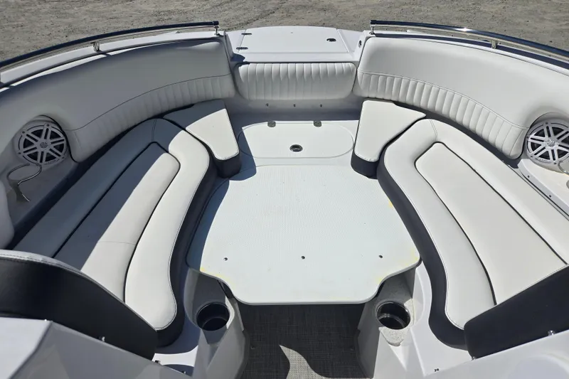 Slide: The Image of Spacious seating area on 2026 Stingray 231 DC boat with white upholstery and cup holders. - 9