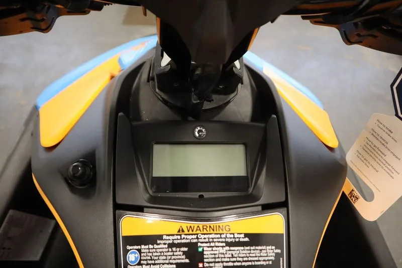 Slide: The Image of 2026 Sea-Doo Spark Trixx dashboard with warning label and display screen. - 10
