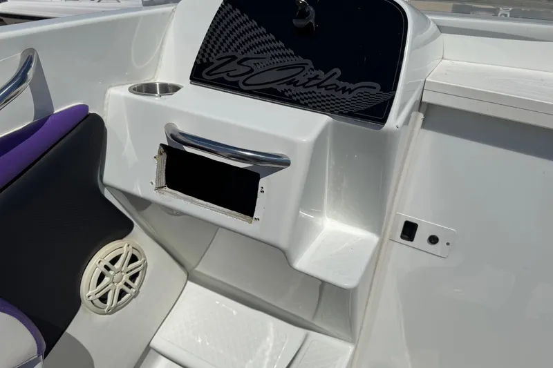 Slide: The Image of 1999 Baja 25 Outlaw boat interior with speaker and cup holder. - 12
