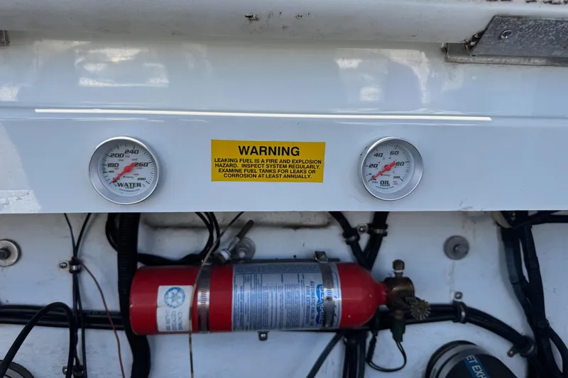 Slide: The Image of 1999 Baja 25 Outlaw dashboard with gauges, warning label, and fire extinguisher. - 15