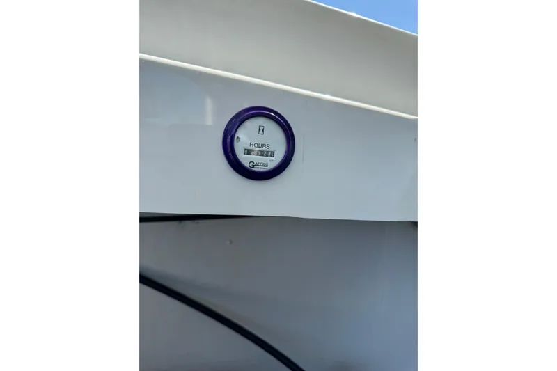 Slide: The Image of Hour meter on 1999 Baja 25 Outlaw boat dashboard, displaying usage hours. - 16