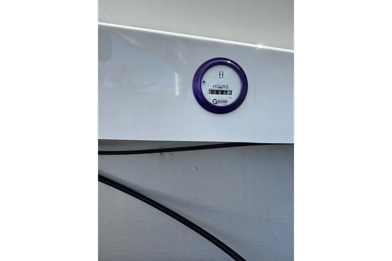 Slide: The Image of Hour meter on a 1999 Baja 25 Outlaw boat, displaying 202.4 hours. - 21
