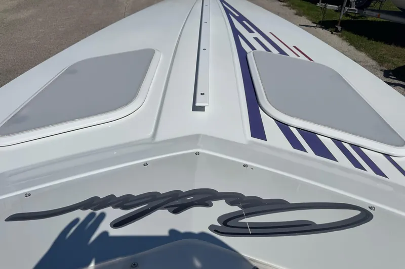 Slide: The Image of 1999 Baja 25 Outlaw boat with sleek design and vibrant graphics. - 25