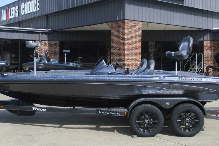 The Image of 2026 Triton 20XP Patriot boat on trailer outside dealership. - 1