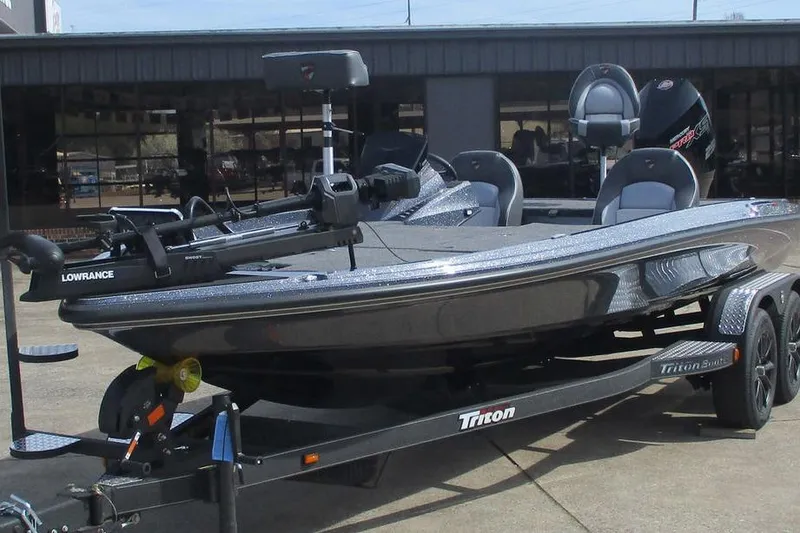 Slide: The Image of 2026 Triton 20XP Patriot fishing boat on trailer, featuring Lowrance equipment. - 11