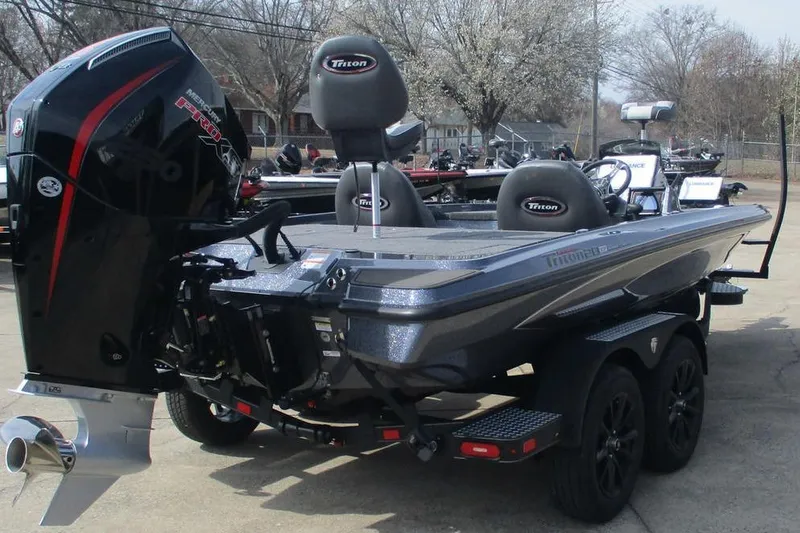 Slide: The Image of 2026 Triton 20XP Patriot boat with powerful engine and sleek design on a trailer. - 3