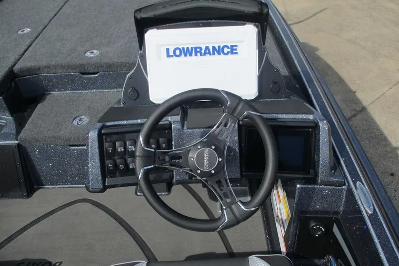 Slide: The Image of Cockpit of 2026 Triton 20XP Patriot boat with steering wheel and Lowrance display. - 4