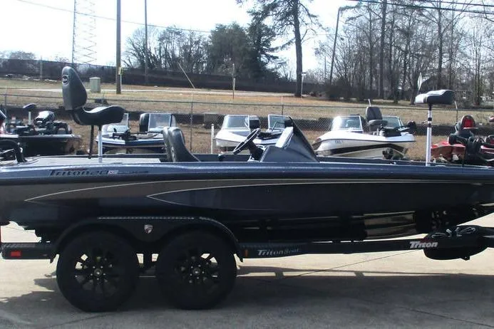 Slide: The Image of 2026 Triton 20XP Patriot boat on trailer, parked outdoors. - 5