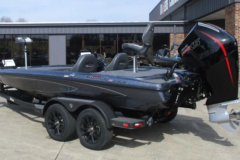 Slide: The Image of 2026 Triton 20XP Patriot boat with powerful engine on trailer, parked outdoors. - 6
