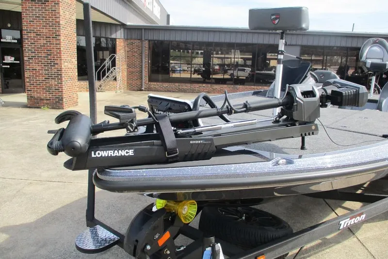 Slide: The Image of 2026 Triton 20XP Patriot boat with Lowrance trolling motor in a dealership lot. - 8