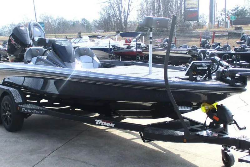 Slide: The Image of 2026 Triton 20XP Patriot boat on trailer, displayed outdoors. - 9