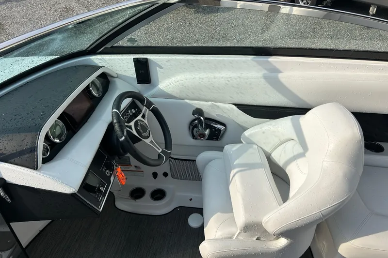 Slide: The Image of 2023 Four Winns HD8 OB boat interior with steering wheel and controls. - 11