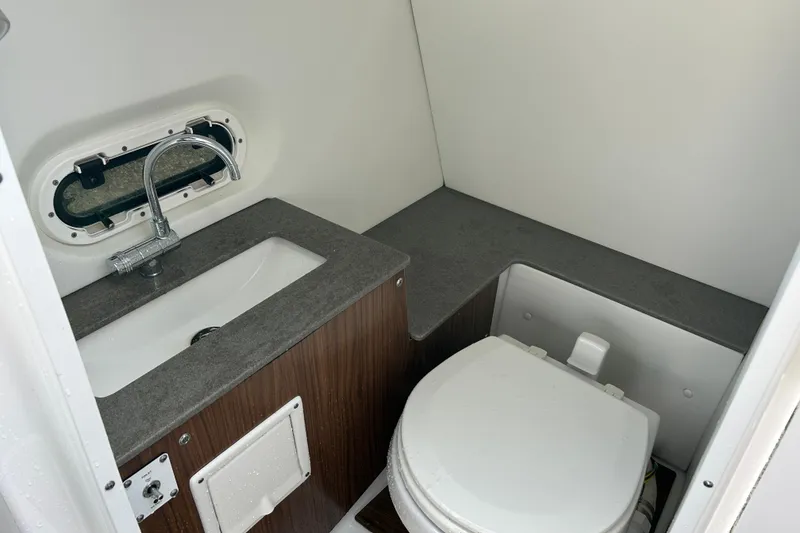 Slide: The Image of 2023 Four Winns HD8 OB boat bathroom with sink and toilet. - 14