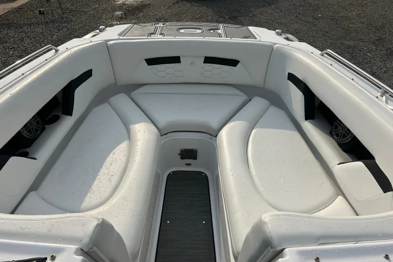 Slide: The Image of 2023 Four Winns HD8 OB boat interior with white cushioned seating. - 15
