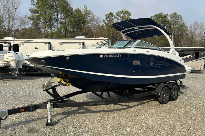 Slide: The Image of 2023 Four Winns HD8 OB boat on trailer, parked outdoors. - 5