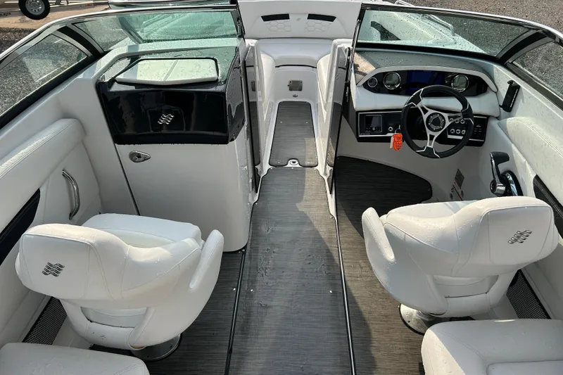 Slide: The Image of 2023 Four Winns HD8 OB boat interior with sleek white seating and modern dashboard. - 9