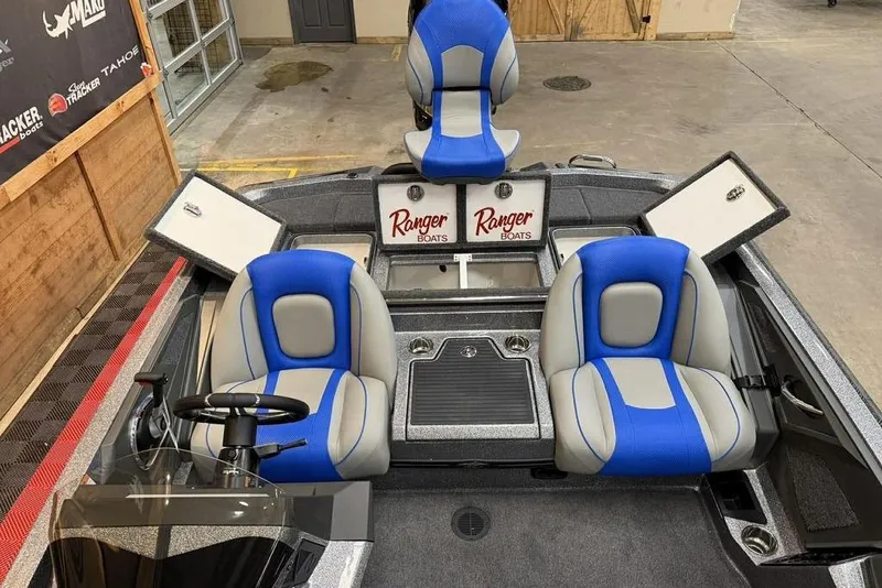 Slide: The Image of 2026 Ranger Z518 Cup-Equipped boat interior with blue and gray seating. - 11