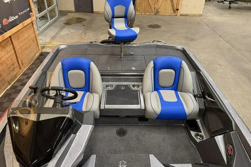 Slide: The Image of 2026 Ranger Z518 Cup-Equipped boat interior with blue and gray seating. - 15