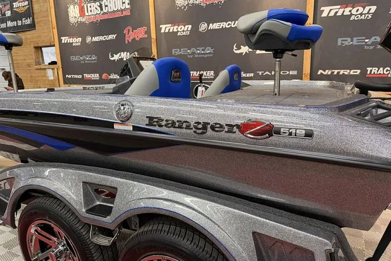 Slide: The Image of 2026 Ranger Z518 Cup-Equipped boat with metallic finish on display at a showroom. - 16
