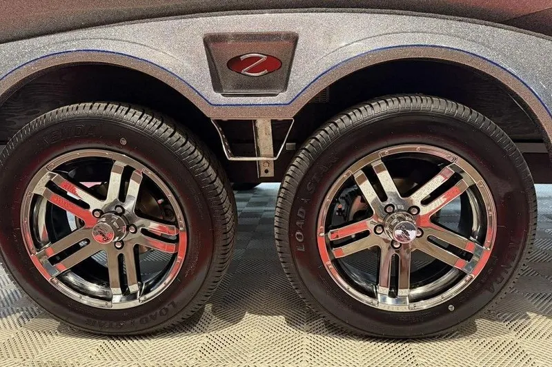 Slide: The Image of 2026 Ranger Z518 Cup-Equipped trailer wheels with chrome rims and black tires. - 17