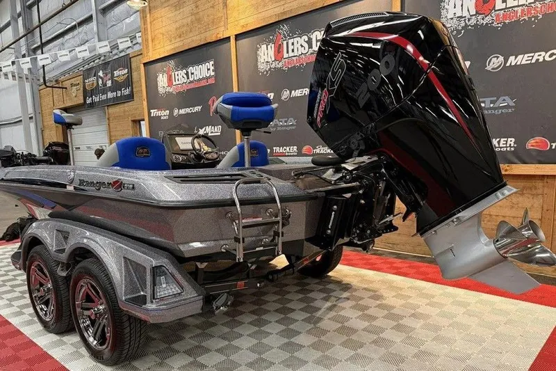 Slide: The Image of 2026 Ranger Z518 Cup-Equipped boat with powerful outboard motor in showroom display. - 2
