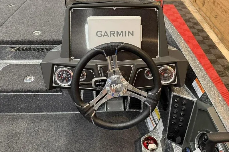 Slide: The Image of 2026 Ranger Z518 Cup-Equipped boat dashboard with Garmin display and steering wheel. - 3