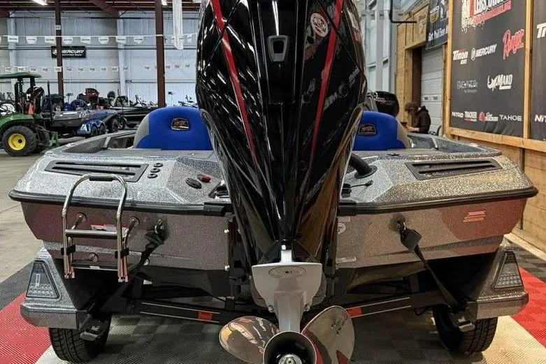 Slide: The Image of 2026 Ranger Z518 Cup-Equipped boat with powerful outboard motor in showroom setting. - 5