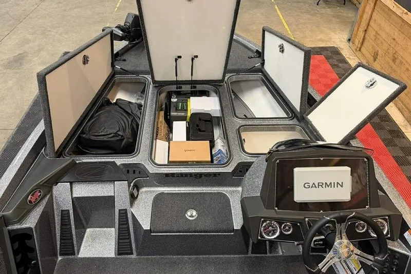 Slide: The Image of 2026 Ranger Z518 Cup-Equipped boat interior with Garmin navigation system and storage compartments open. - 6