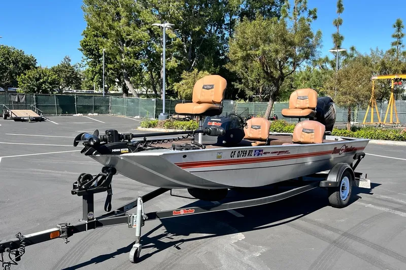 The Image of 2018 TRACKER BOAT Classic 18 on trailer in parking lot, surrounded by trees. - 1