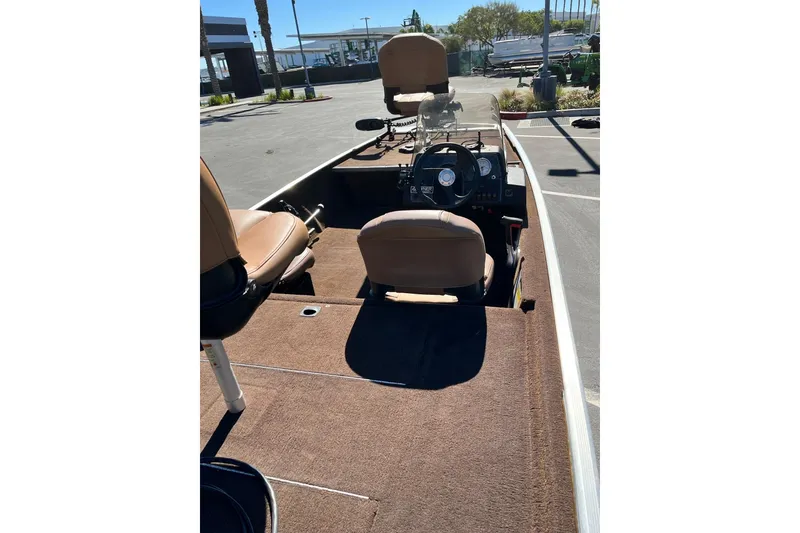 Slide: The Image of 2018 TRACKER BOAT Classic 18 interior with brown seats and steering console. - 5