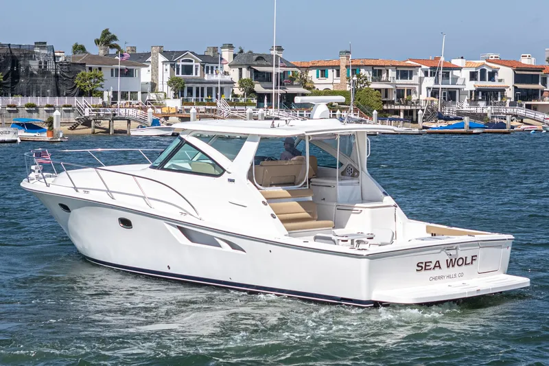 The Image of 2018 Tiara Yachts 43 Open cruising near waterfront homes. - 0