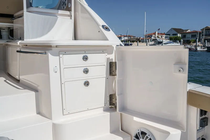 Slide: The Image of 2018 Tiara Yachts 43 Open with open storage compartment at the harbor. - 20