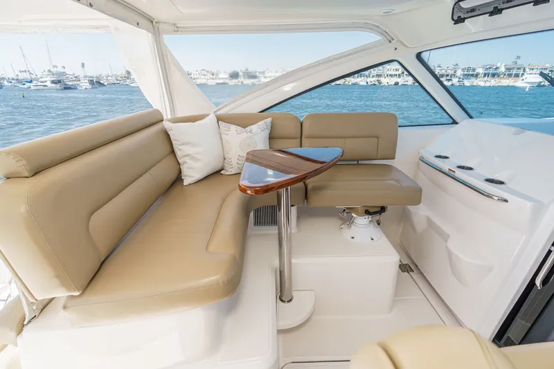 Slide: The Image of Interior of 2018 Tiara Yachts 43 Open with beige sofa and wooden table. - 23
