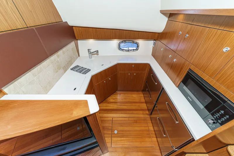 Slide: The Image of 2018 Tiara Yachts 43 Open kitchen with wood cabinetry and modern appliances. - 39