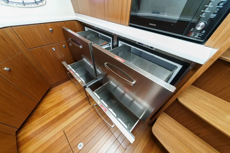Slide: The Image of Interior of 2018 Tiara Yachts 43 Open with stainless steel drawer refrigerator. - 41