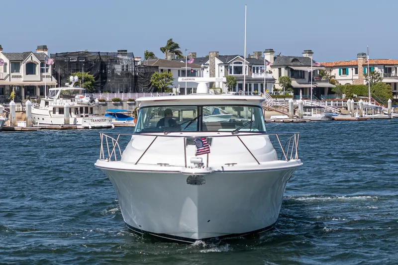 Slide: The Image of 2018 Tiara Yachts 43 Open in front of coastal homes. - 7
