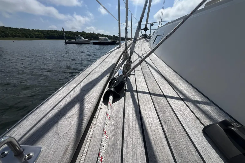 Slide: The Image of Deck view of a 2017 Rustler 37 sailboat on calm water. - 12