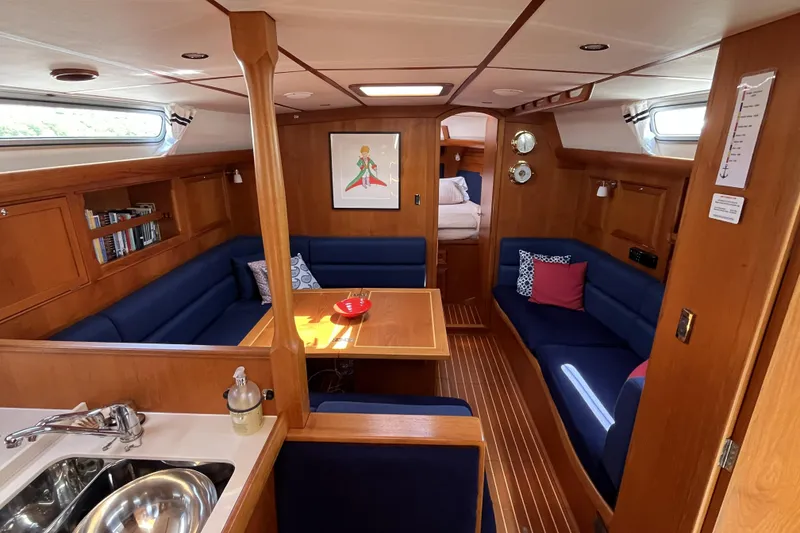 Slide: The Image of Interior of a 2017 Rustler 37 yacht with cozy seating and wooden finishes. - 19