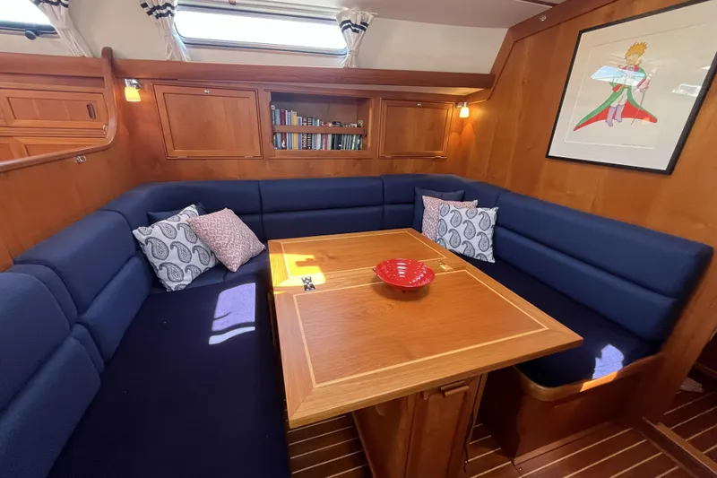 Slide: The Image of Cozy interior of 2017 Rustler 37 yacht with blue seating and wooden table. - 23