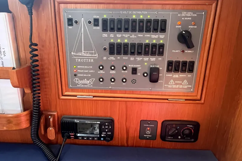 Slide: The Image of Electrical control panel on a 2017 Rustler 37 yacht, featuring switches and gauges. - 25