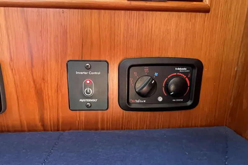 Slide: The Image of Inverter and heater controls on 2017 Rustler 37 yacht's wooden panel. - 28