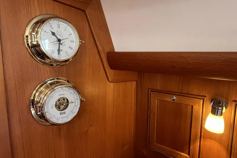 Slide: The Image of Luxurious wooden interior of 2017 Rustler 37 yacht with brass clock and barometer. - 36
