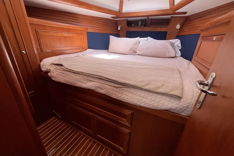Slide: The Image of Luxurious cabin interior of 2017 Rustler 37 yacht with cozy bedding and wooden finish. - 37
