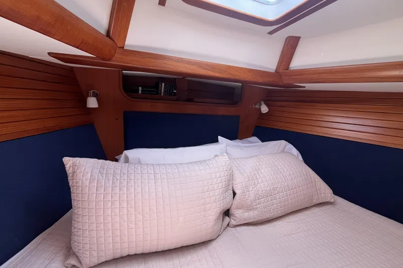 Slide: The Image of Cozy cabin interior of 2017 Rustler 37 yacht with wooden accents and plush bedding. - 39