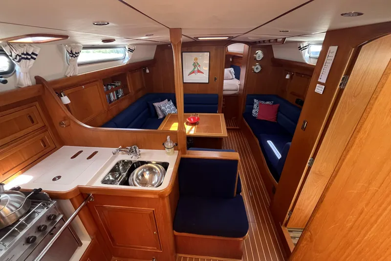 Slide: The Image of Interior of 2017 Rustler 37 yacht with wooden finish and cozy seating area. - 4