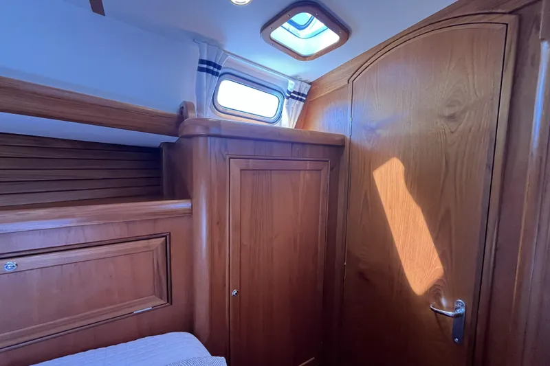 Slide: The Image of Interior of 2017 Rustler 37 yacht with wooden cabinetry and porthole window. - 40