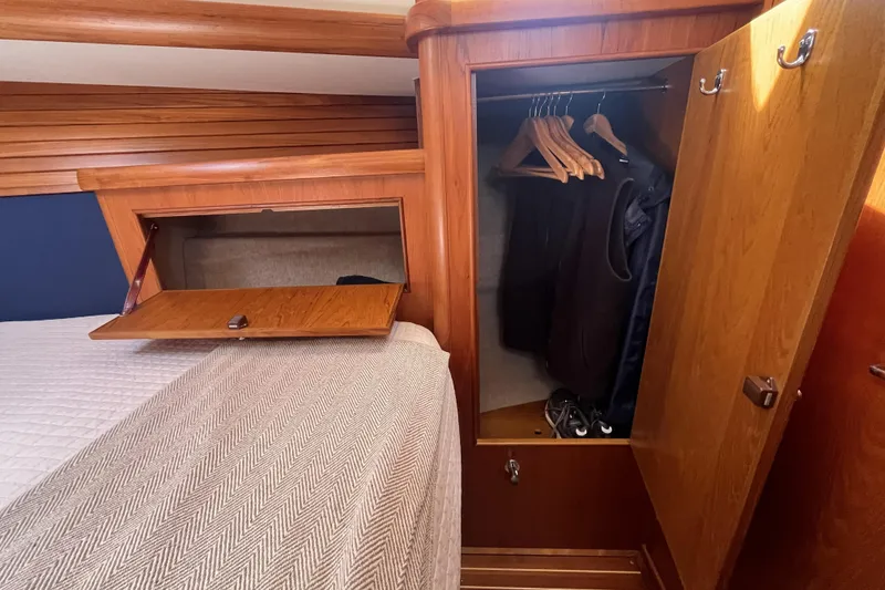 Slide: The Image of Wooden interior of 2017 Rustler 37 yacht with open closet and bed storage. - 41