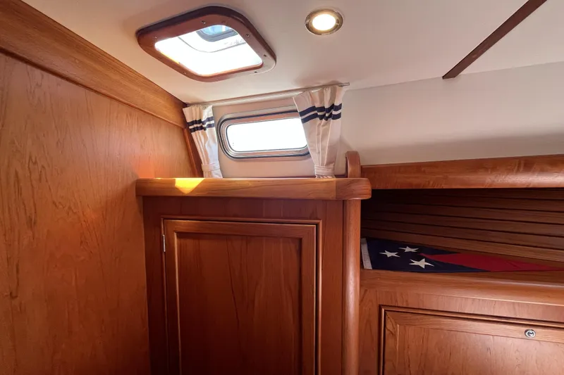 Slide: The Image of Interior of 2017 Rustler 37 yacht with wooden cabinetry and nautical decor. - 42