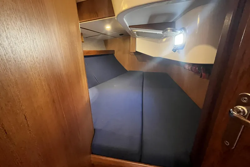 Slide: The Image of Cozy cabin interior of 2017 Rustler 37 yacht with wooden finish and blue bedding. - 47